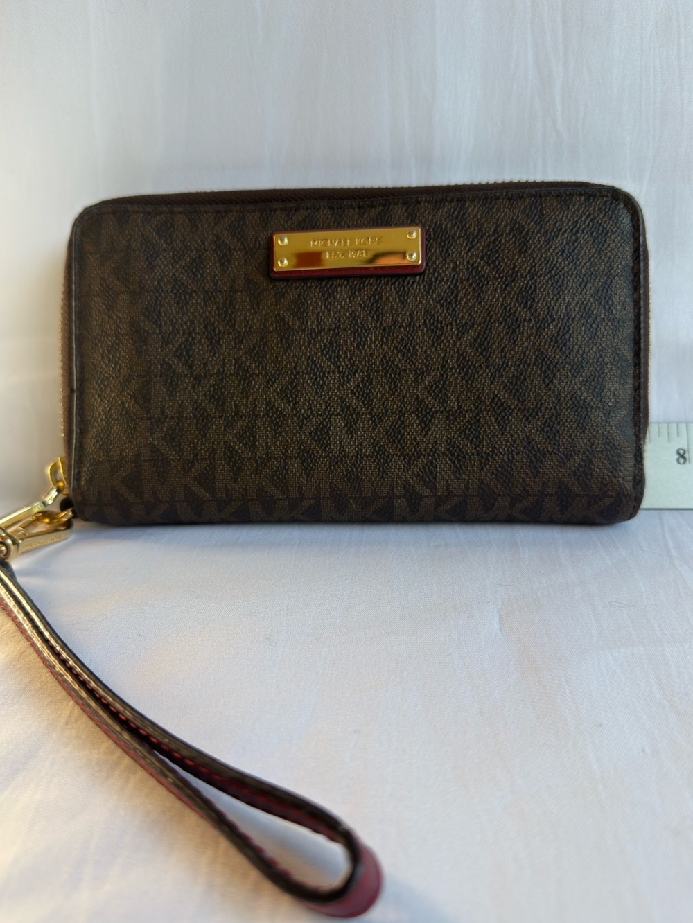 Michael Kors Dark Brown Monogram Leather Zip Wristlet with Gold Plate